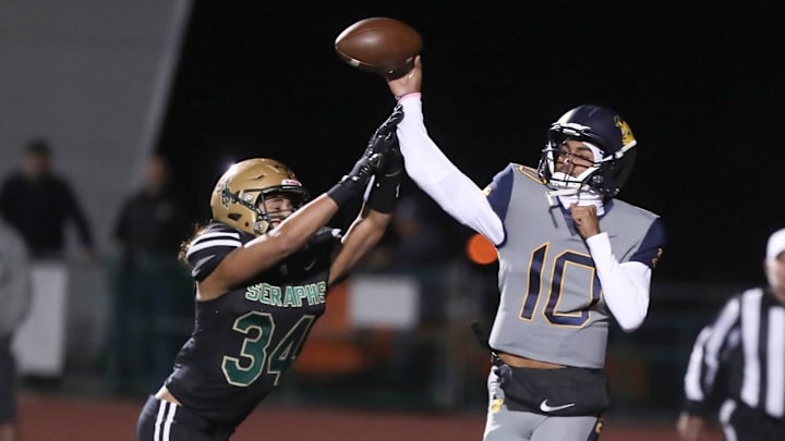 Warren quarterback Madden Iamaleava is under pressure by St. Bonaventure's Jacob Moraga in November 2023.