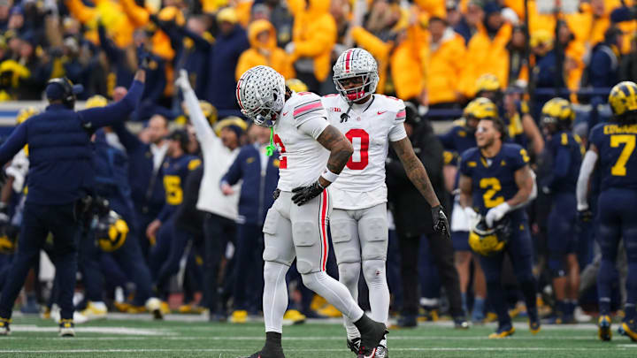 Nov 25, 2023; Ann Arbor, Michigan, USA; After a Michigan Wolverines interception all but ended the game, Ohio State Buckeyes wide receiver Emeka Egbuka (2) and wide receiver Xavier Johnson (0) walk off the field in the final seconds of the second half of the NCAA football game at Michigan Stadium. Ohio State lost 30-24.