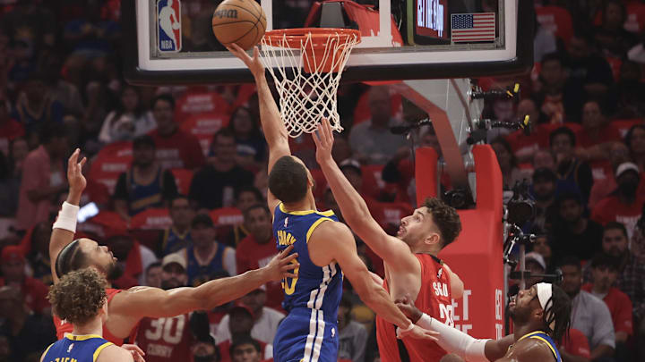 Apr 30, 2025; Houston, Texas, USA; Golden State Warriors guard Stephen Curry (30) tips away a defensive rebound against Houston Rockets center Alperen Sengun (28) in the first quarter during game five of first round for the 2025 NBA Playoffs at Toyota Center. Mandatory Credit: Thomas Shea-Imagn Images