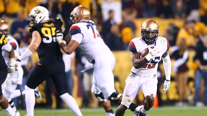 Nov 30, 2013; Tempe, AZ, USA; Arizona Wildcats running back Ka'Deem Carey (25) against the Arizona State Sun Devils in the 87th annual Territorial Cup at Sun Devil Stadium. Mandatory Credit: Mark J. Rebilas-Imagn Images
