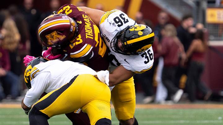Iowa Hawkeyes linebacker Jayden Montgomery (36) and Iowa Hawkeyes defensive back Jaylen Watson (3) tackle Minnesota’s TJ Thomas (23) Oct. 24, 2026 during a Big Ten football game in Minneapolis, Minnesota.