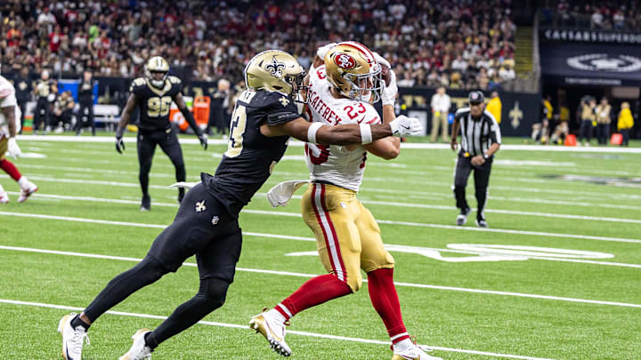 Sep 14, 2025; New Orleans, Louisiana, USA; New Orleans Saints safety Jonas Sanker (33) tackles San Francisco 49ers running back Christian McCaffrey (23) after a catch during the first half at Caesars Superdome. Mandatory Credit: Stephen Lew-Imagn Images Sep 14, 2025; New Orleans, Louisiana, USA; New Orleans Saints safety Jonas Sanker (33) tackles San Francisco 49ers running back Christian McCaffrey (23) after a catch during the first half at Caesars Superdome. Mandatory Credit: Stephen Lew-Imagn Images