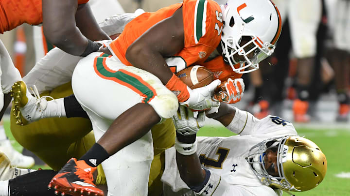 Nov 11, 2017; Miami Gardens, FL, USA; Miami Hurricanes defensive lineman Jonathan Garvin (97) recovers a ball fumbled by Notre Dame Fighting Irish quarterback Brandon Wimbush (7) in the fourth quarter at Hard Rock Stadium. Mandatory Credit: Matt Cashore-Imagn Images