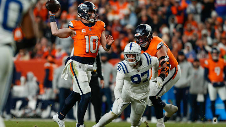 Dec 15, 2024; Denver, Colorado, USA; Denver Broncos quarterback Bo Nix (10) throws for a touchdown against Indianapolis Colts defensive end Laiatu Latu (97) as offensive tackle Garett Bolles (72) defends in the fourth quarter at Empower Field at Mile High. Mandatory Credit: Isaiah J. Downing-Imagn Images Dec 15, 2024; Denver, Colorado, USA; Denver Broncos quarterback Bo Nix (10) throws for a touchdown against Indianapolis Colts defensive end Laiatu Latu (97) as offensive tackle Garett Bolles (72) defends in the fourth quarter at Empower Field at Mile High. Mandatory Credit: Isaiah J. Downing-Imagn Images