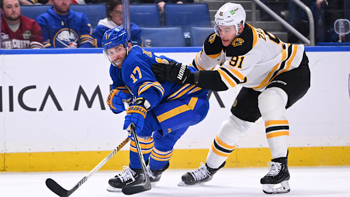 January 28th, 2025; Buffalo, New York, USA;  Buffalo Sabres winger Jason Zucker (17) battles for the puck against Boston Bruins defencemen Nikita Zadorov (91). 