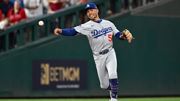 Oct 6, 2025; Philadelphia, Pennsylvania, USA; Los Angeles Dodgers shortstop Mookie Betts (50) makes a play to get out Philadelphia Phillies catcher J.T. Realmuto (not pictured) at first base in the second inning during game two of the NLDS round for the 2025 MLB playoffs at Citizens Bank Park. Mandatory Credit: Eric Hartline-Imagn Images