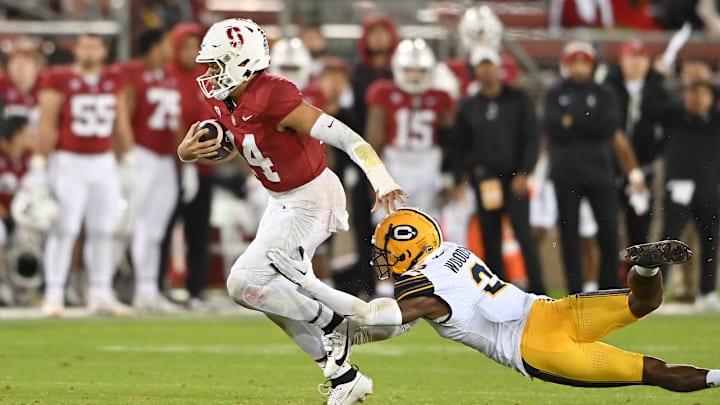 Nov 18, 2023; Stanford, California, USA; California Golden Bears defensive back Craig Woodson (2) dives in an attempt to tackle Stanford Cardinal quarterback Ashton Daniels (14) during the third quarter at Stanford Stadium. Mandatory Credit: Robert Edwards-Imagn Images Nov 18, 2023; Stanford, California, USA; California Golden Bears defensive back Craig Woodson (2) dives in an attempt to tackle Stanford Cardinal quarterback Ashton Daniels (14) during the third quarter at Stanford Stadium. Mandatory Credit: Robert Edwards-Imagn Images