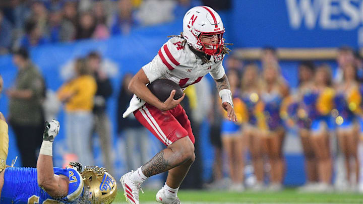Nov 8, 2025; Pasadena, California, USA; Nebraska Cornhuskers quarterback TJ Lateef (14) runs the ball ahead of UCLA Bruins defensive lineman Jacob Busic (97) during the second half at the Rose Bowl. Mandatory Credit: Gary A. Vasquez-Imagn Images Nov 8, 2025; Pasadena, California, USA; Nebraska Cornhuskers quarterback TJ Lateef (14) runs the ball ahead of UCLA Bruins defensive lineman Jacob Busic (97) during the second half at the Rose Bowl. Mandatory Credit: Gary A. Vasquez-Imagn Images