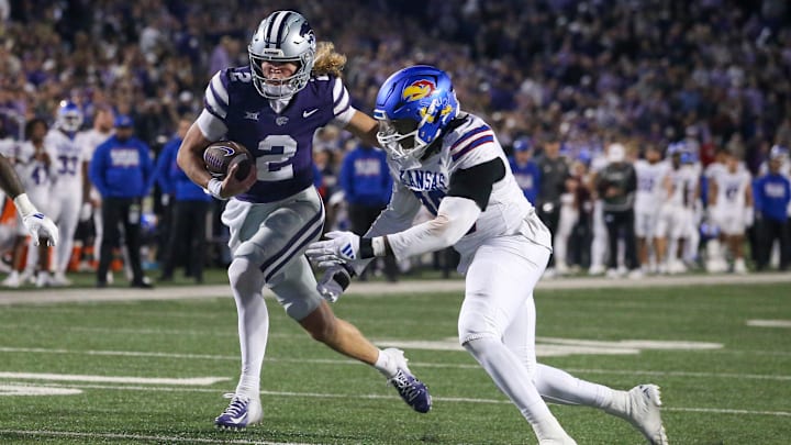 Avery Johnson of Kansas State tries to get away from Kansas edge rusher Jereme Robinson, a Bears undrafted player.