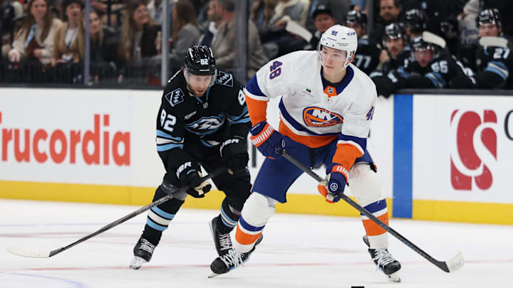 Nov 14, 2025; Salt Lake City, Utah, USA; New York Islanders defenseman Matthew Schaefer (48) skates with the puck against Utah Mammoth center Logan Cooley (92) during the second period at Delta Center. Mandatory Credit: Rob Gray-Imagn Images