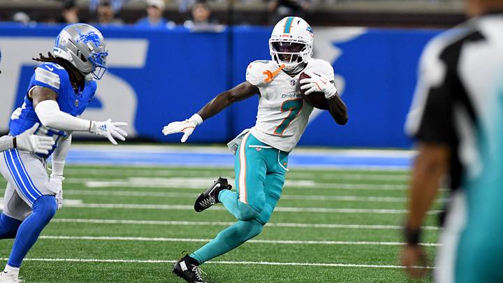 Miami Dolphins wide receiver Tahj Washington (7) runs the ball against the Detroit Lions in the first quarter at Ford Field during the 2025 preseason. Miami Dolphins wide receiver Tahj Washington (7) runs the ball against the Detroit Lions in the first quarter at Ford Field during the 2025 preseason.