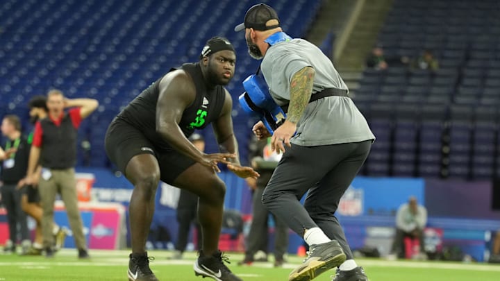Mar 1, 2026; Indianapolis, IN, USA; Georgia offensive lineman Micah Morris (OL36) interacts with the Los Angeles Chargers assistant offensive line coach Nick Hardwick during the NFL Scouting Combine at Lucas Oil Stadium. Mandatory Credit: Kirby Lee-Imagn Images
