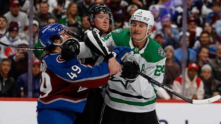 Apr 23, 2025; Denver, Colorado, USA; Linesman CJ Murray (68) separates Colorado Avalanche defenseman Samuel Girard (49) and Dallas Stars center Roope Hintz (24) in the first period in game three of the first round of the 2025 Stanley Cup Playoffs at Ball Arena. Mandatory Credit: Isaiah J. Downing-Imagn Images