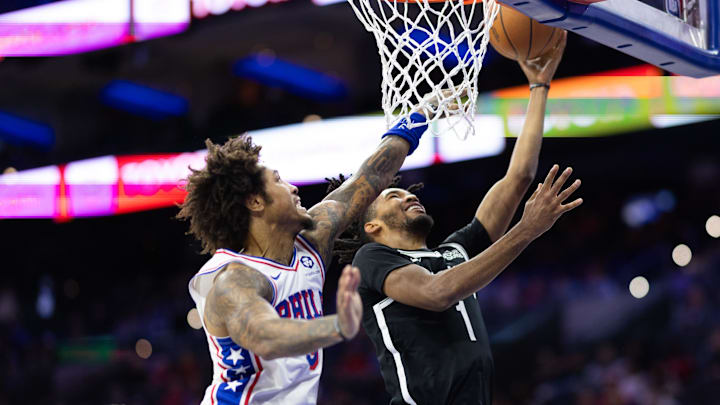 Oct 16, 2024; Philadelphia, Pennsylvania, USA;  Brooklyn Nets Ziaire Williams (1) drives for a shot against Philadelphia 76ers guard Kelly Oubre Jr. (9) during the second quarter at Wells Fargo Center. Mandatory Credit: Bill Streicher-Imagn Images