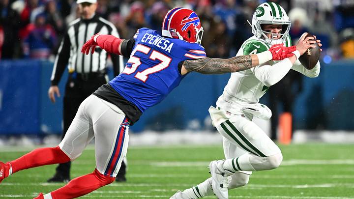 Jan 4, 2026; Orchard Park, New York, USA; New York Jets quarterback Brady Cook (4) scrambles with the ball under pressure from Buffalo Bills defensive end AJ Epenesa (57) during the first half at Highmark Stadium. Mandatory Credit: Mark Konezny-Imagn Images Jan 4, 2026; Orchard Park, New York, USA; New York Jets quarterback Brady Cook (4) scrambles with the ball under pressure from Buffalo Bills defensive end AJ Epenesa (57) during the first half at Highmark Stadium. Mandatory Credit: Mark Konezny-Imagn Images