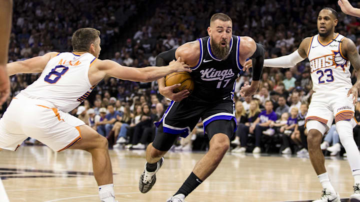 Apr 13, 2025; Sacramento, California, USA;  Sacramento Kings center Jonas Valanciunas (17) drives past Phoenix Suns guard Grayson Allen (8) during the second quarter at Golden 1 Center. Mandatory Credit: John Hefti-Imagn Images