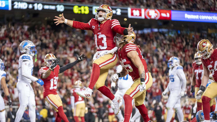 December 30, 2024; Santa Clara, California, USA; San Francisco 49ers quarterback Brock Purdy (13) celebrates with tight end George Kittle (85) after scoring a touchdown against the Detroit Lions during the second quarter at Levi's Stadium. Mandatory Credit: Kyle Terada-Imagn Images