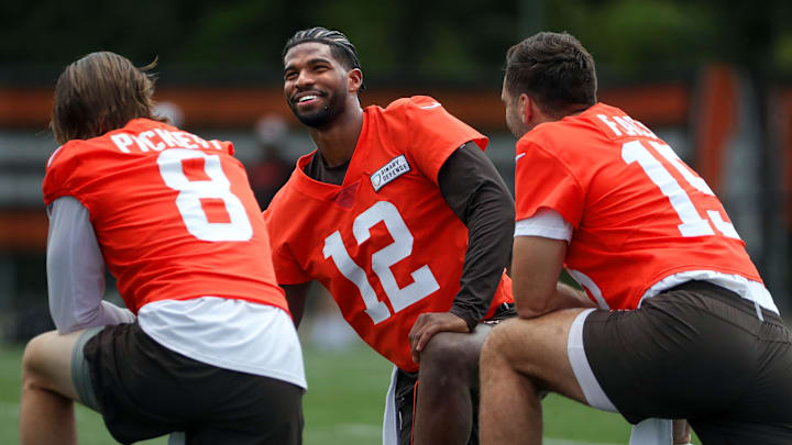 Browns quarterbacks Shedeur Sanders (12), Kenny Pickett (8) and Joe Flacco (15) talk during minicamp June 10, 2025, in Berea.