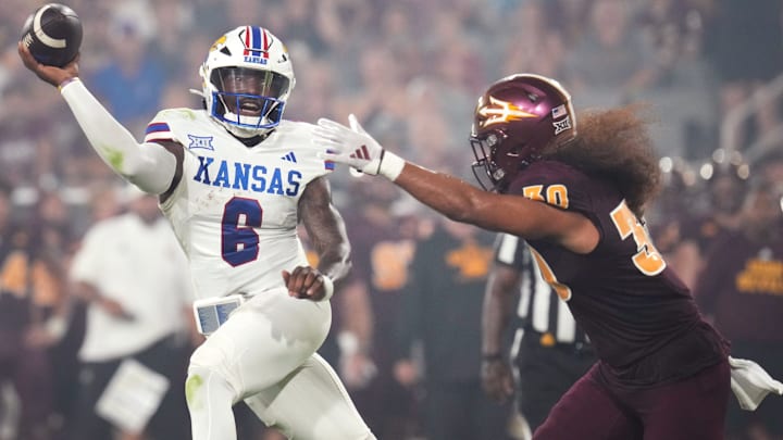Arizona State linebacker Zyrus Fiaseu (30) closes in on Kansas quarterback Jalon Daniels (6) at Mountain America Stadium on Oct. 5, 2024.
