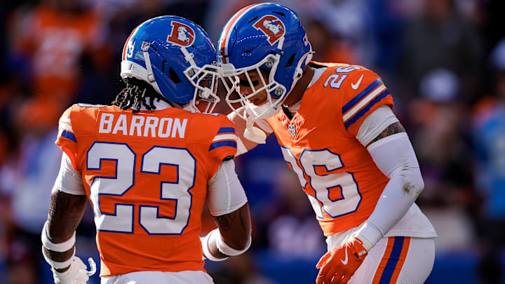 Jan 4, 2026; Denver, Colorado, USA; Denver Broncos safety Devon Key (26) reacts with cornerback Jahdae Barron (23) after a play in the first quarter against the Los Angeles Chargers at Empower Field at Mile High. Jan 4, 2026; Denver, Colorado, USA; Denver Broncos safety Devon Key (26) reacts with cornerback Jahdae Barron (23) after a play in the first quarter against the Los Angeles Chargers at Empower Field at Mile High.