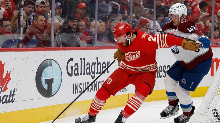 Jan 31, 2026; Detroit, Michigan, USA;  Detroit Red Wings center Michael Rasmussen (27) and Colorado Avalanche defenseman Josh Manson (42) battle for the puck in the second period at Little Caesars Arena. Mandatory Credit: Rick Osentoski-Imagn Images
