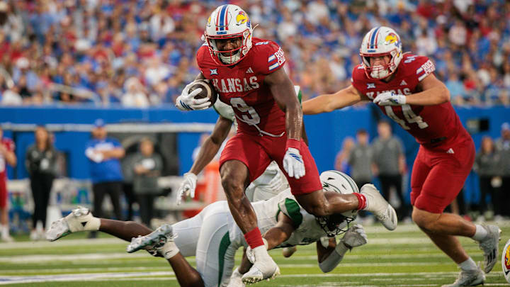 Aug 29, 2025; Lawrence, Kansas, USA; Kansas Jayhawks running back Daniel Hishaw Jr. (9) runs the ball during the second half against the Wagner Seahawks at David Booth Kansas Memorial Stadium. Mandatory Credit: William Purnell-Imagn Images
