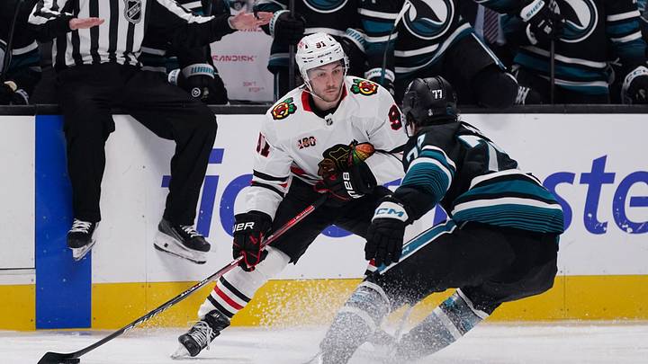 Apr 6, 2026; San Jose, California, USA;  Chicago Blackhawks center Frank Nazar (91) controls the puck against San Jose Sharks center Michael Misa (77) in the third period at SAP Center at San Jose. Mandatory Credit: David Gonzales-Imagn Images