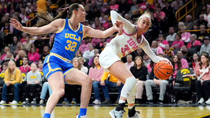 Iowa guard Lucy Olsen (33) drives along the baseline against UCLA forward Angela Dugalic (32) Sunday, Feb. 23, 2025 at Carver-Hawkeye Arena in Iowa City, Iowa. Iowa guard Lucy Olsen (33) drives along the baseline against UCLA forward Angela Dugalic (32) Sunday, Feb. 23, 2025 at Carver-Hawkeye Arena in Iowa City, Iowa.