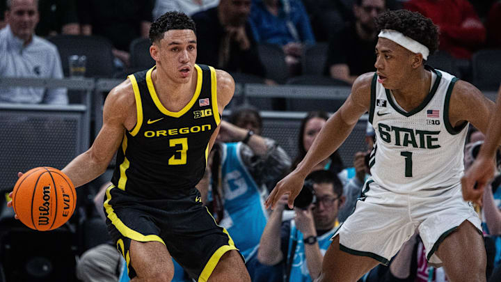 Mar 14, 2025; Indianapolis, IN, USA;  Oregon Ducks guard Jackson Shelstad (3) dribbles the ball while Michigan State Spartans guard Jeremy Fears Jr. (1) defends in the first half  at Gainbridge Fieldhouse. Mandatory Credit: Trevor Ruszkowski-Imagn Images