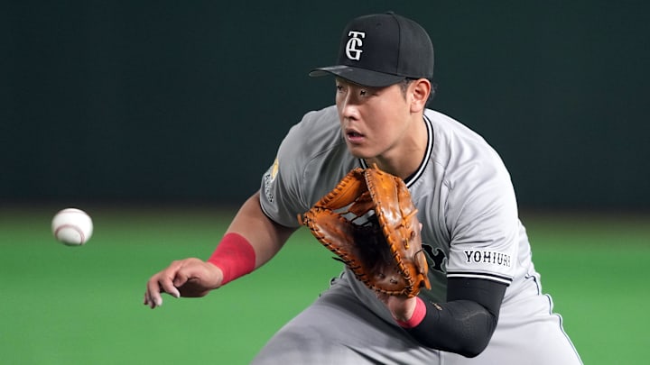 Yomiuri Giants first baseman Kazuma Okamoto (25) fields a ground ball against the Los Angeles Dodgers at Tokyo Dome. 