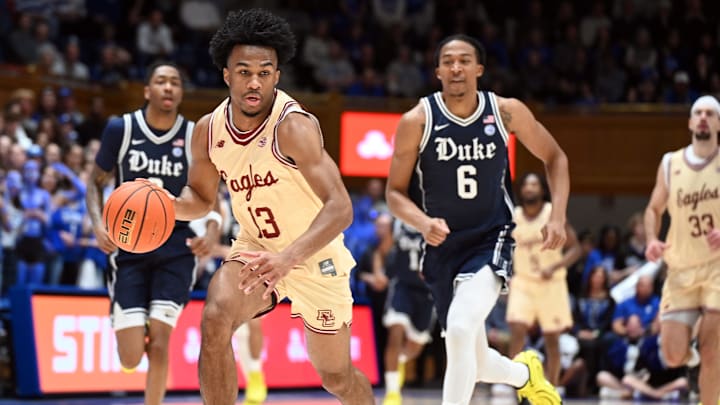 Feb 3, 2026; Durham, North Carolina, USA;  Boston College Eagles guard Donald Hand Jr. (13) drives to the basket as Duke Blue Devils forward Maliq Brown (6) pursues during the first half at Cameron Indoor Stadium. Mandatory Credit: Rob Kinnan-Imagn Images