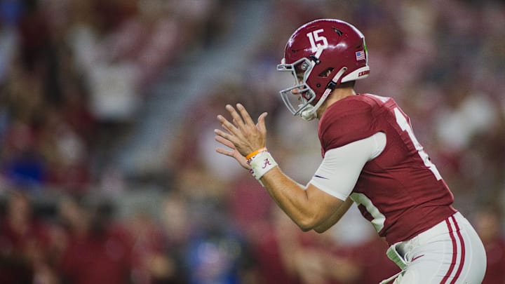 Aug 31, 2024; Tuscaloosa, Alabama, USA;  Alabama Crimson Tide quarterback Ty Simpson (15) reaches out for a snap during the fourth quarter at Bryant-Denny Stadium. Mandatory Credit: Will McLelland-Imagn Images
