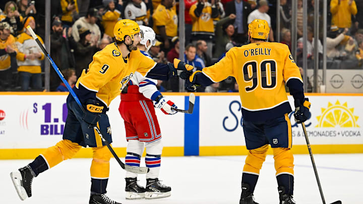 Dec 21, 2025; Nashville, Tennessee, USA;  Nashville Predators left wing Filip Forsberg (9) and center Ryan O'Reilly (90) celebrate the win during the third period at Bridgestone Arena. Mandatory Credit: Steve Roberts-Imagn Images