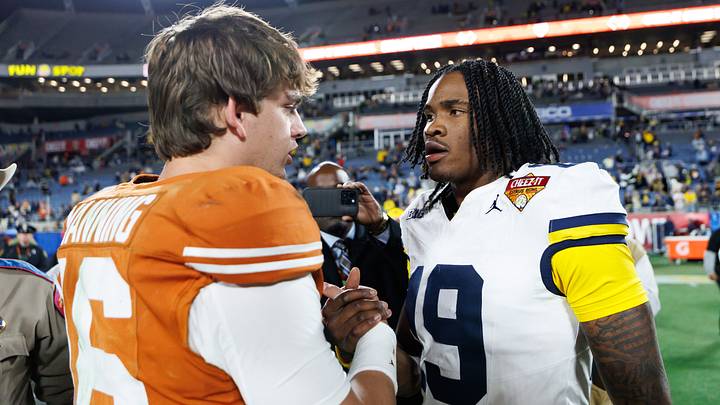 Texas Longhorns quarterback Arch Manning (16) and Michigan Wolverines quarterback Bryce Underwood (19) shake hands after a game at Camping World Stadium. Texas Longhorns quarterback Arch Manning (16) and Michigan Wolverines quarterback Bryce Underwood (19) shake hands after a game at Camping World Stadium.