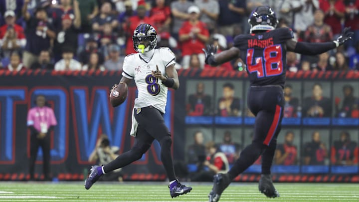 Baltimore Ravens quarterback Lamar Jackson scrambles with the ball during the second quarter against the Houston Texans at NRG Stadium on Christmas Day. 