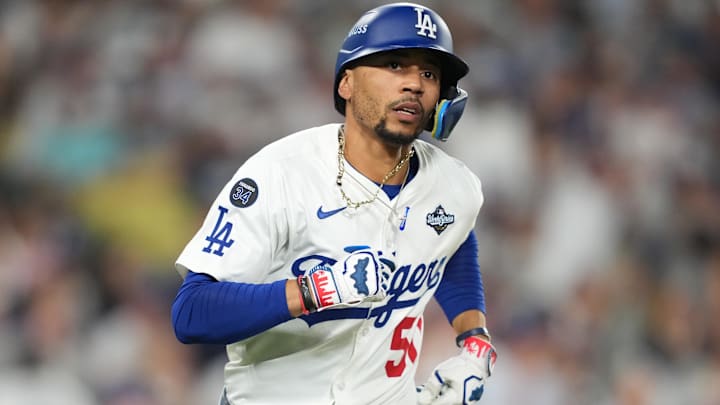 Los Angeles Dodgers shortstop Mookie Betts (50) runs after hitting a single against the Toronto Blue Jays in the eighth inning during game four of the 2025 MLB World Series at Dodger Stadium.