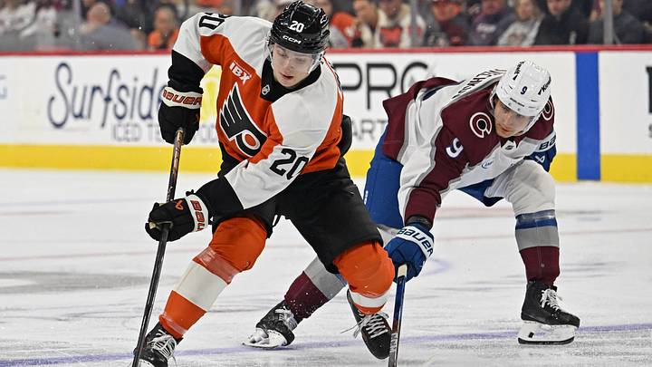 Oct 19, 2026; Philadelphia, Pennsylvania, USA; Philadelphia Flyers left wing Alex Bump (20) is defended by Colorado Avalanche center Fedor Svechkov (9) during the third period at Xfinity Mobile Arena. 