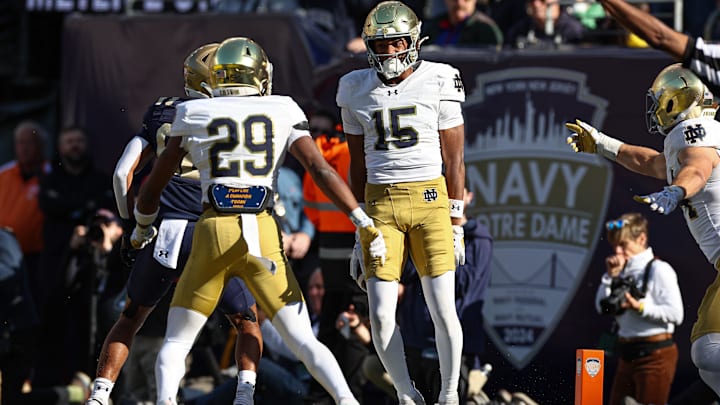 Oct 26, 2024; East Rutherford, New Jersey, USA; Notre Dame Fighting Irish cornerback Leonard Moore (15) celebrates his interception with cornerback Christian Gray (29) during the second half against the Navy Midshipmen at MetLife Stadium. Mandatory Credit: Vincent Carchietta-Imagn Images