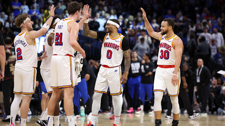 Feb 27, 2025; Orlando, Florida, USA; Golden State Warriors guard Stephen Curry (30) celebrates with guard Gary Payton II (0) center Quinten Post (21) after a play against the Orlando Magic in the fourth quarter at Kia Center. Mandatory Credit: Nathan Ray Seebeck-Imagn Images