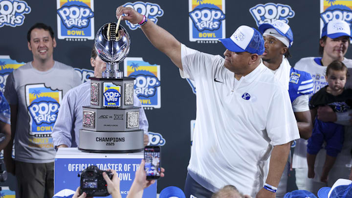 Dec 27, 2025; Orlando, FL, USA; BYU Cougars head coach Kalani Sitake celebrates after beating Georgia Tech Yellow Jackets in the Pop-Tarts Bowl at Camping World Stadium. Mandatory Credit: Nathan Ray Seebeck-Imagn Images