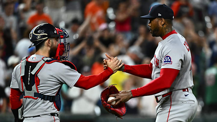 Aug 27, 2025; Baltimore, Maryland, USA;  Boston Red Sox catcher Connor Wong (12) celebrates a win against the Baltimore Orioles with pitcher Aroldis Chapman (44) at Oriole Park at Camden Yards. Mandatory Credit: James A. Pittman-Imagn Images