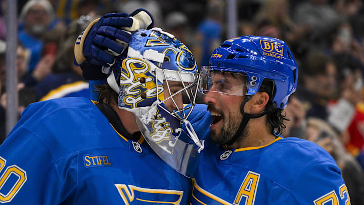 Oct 19, 2024; St. Louis, Missouri, USA;  St. Louis Blues defenseman Justin Faulk (72) and goaltender Joel Hofer (30) celebrate after the Blues defeated the Carolina Hurricanes at Enterprise Center. Mandatory Credit: Jeff Curry-Imagn Images