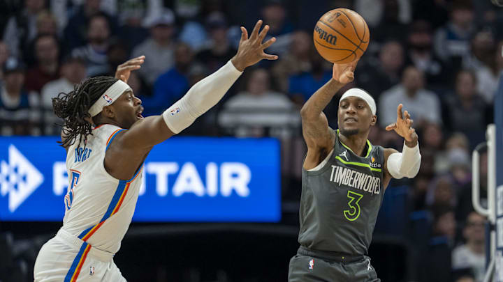 Minnesota Timberwolves forward Jaden McDaniels passes the ball around Oklahoma City Thunder guard Luguentz Dort in the first half at Target Center in Minneapolis on Feb. 23, 2025. Minnesota Timberwolves forward Jaden McDaniels passes the ball around Oklahoma City Thunder guard Luguentz Dort in the first half at Target Center in Minneapolis on Feb. 23, 2025.