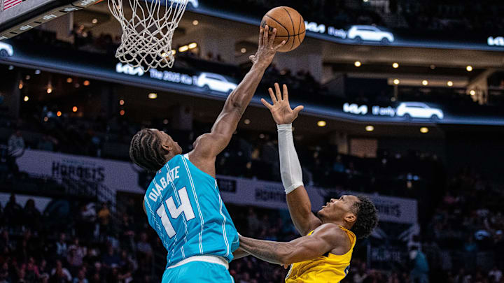 Nov 8, 2024; Charlotte, North Carolina, USA; Charlotte Hornets forward Moussa Diabate (14) blocks a shot by Indiana Pacers guard Bennedict Mathurin (00) during the third quarter at Spectrum Center. Mandatory Credit: Scott Kinser-Imagn Images