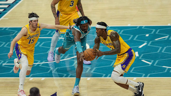 Jan 27, 2025; Charlotte, North Carolina, USA; Charlotte Hornets center Mark Williams (5) tries for a steal from Los Angeles Lakers forward Jarred Vanderbilt (2) during the second half at the Spectrum Center. Mandatory Credit: Jim Dedmon-Imagn Images
