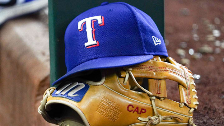 Apr 28, 2025; Arlington, Texas, USA; A Texas Rangers cap and baseball mitt sit on the dugout steps during a game against the Athletics at Globe Life Field. Apr 28, 2025; Arlington, Texas, USA; A Texas Rangers cap and baseball mitt sit on the dugout steps during a game against the Athletics at Globe Life Field.