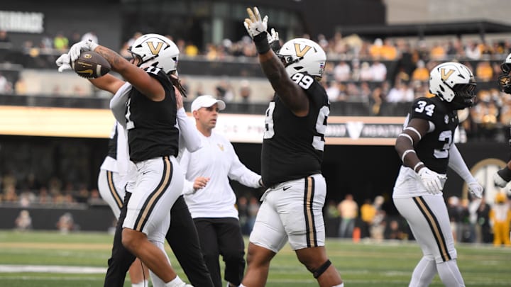 Oct 25, 2025; Nashville, Tennessee, USA; Vanderbilt Commodores defensive players celebrate after a goal-line stand against the Missouri Tigers during the third quarter at FirstBank Stadium. Mandatory Credit: Steve Roberts-Imagn Images Oct 25, 2025; Nashville, Tennessee, USA; Vanderbilt Commodores defensive players celebrate after a goal-line stand against the Missouri Tigers during the third quarter at FirstBank Stadium. Mandatory Credit: Steve Roberts-Imagn Images