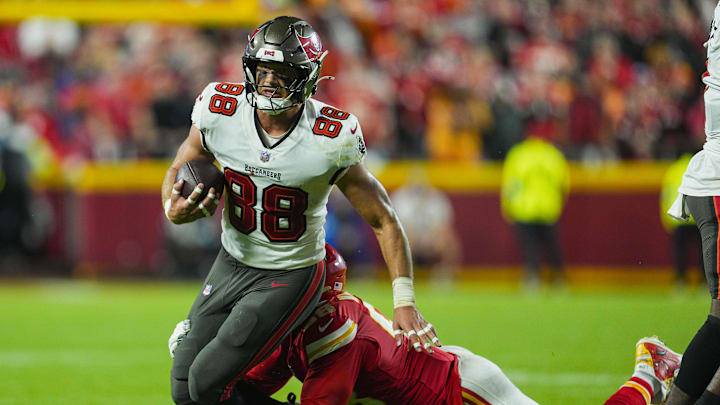 Nov 4, 2024; Kansas City, Missouri, USA; Tampa Bay Buccaneers tight end Cade Otton (88) is tackled by Kansas City Chiefs defensive tackle Tershawn Wharton (98) during the second half at GEHA Field at Arrowhead Stadium. Mandatory Credit: Jay Biggerstaff-Imagn Images