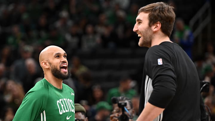 Jan 10, 2026; Boston, Massachusetts, USA; Boston Celtics guard Derrick White (9) talks with San Antonio Spurs center Luke Kornet (7) before a game at the TD Garden.
