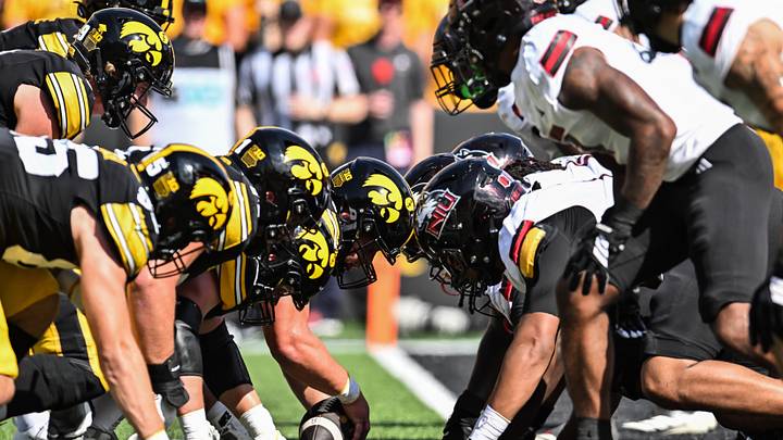 Sep 5, 2026; Iowa City, Iowa, USA;  Iowa Hawkeyes quarterback Hank Brown (9) takes the snap from offensive lineman Cael Winter (61) at the line of scrimmage against the Northern Illinois Huskies during the first quarter at Kinnick Stadium.  Mandatory Credit: Jeffrey Becker-Imagn Images